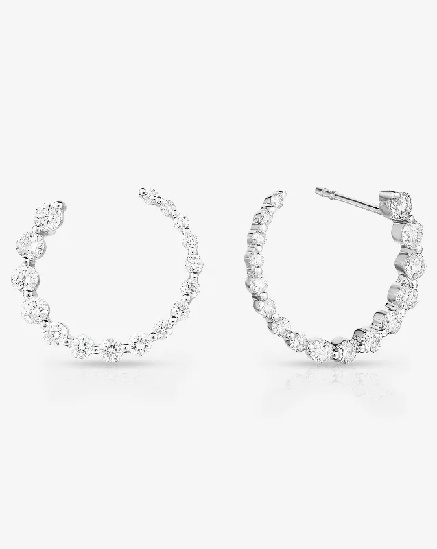 Paired gemstone earrings-Graduated Single Prong Diamond Circle Studs